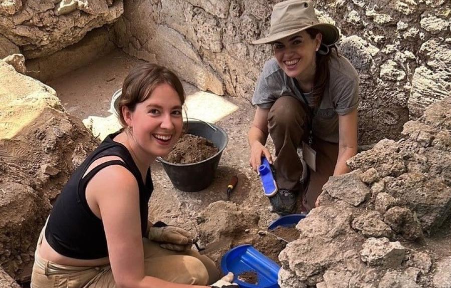 Student and professor at archaeological dig