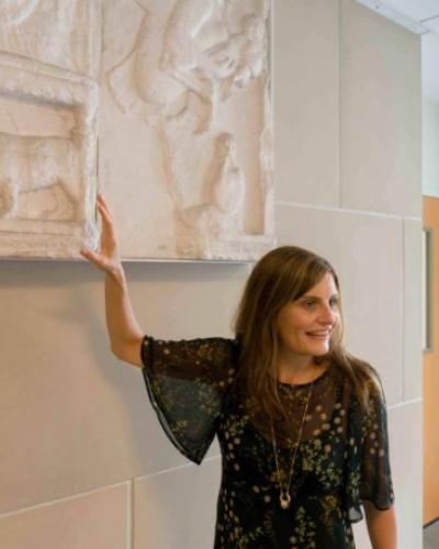 Verity Platt gesturing towards a frieze